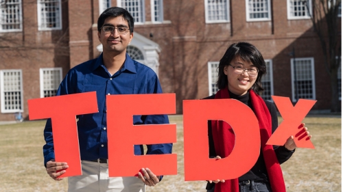 The organizers of TedX Dartmouth hold up cutouts of the letters TEDX