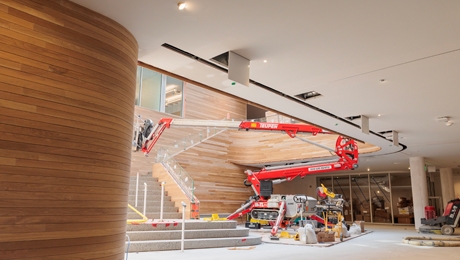 The Hop forum - a welcoming, sunlit entryway with curved wooden paneling