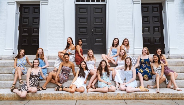 The Decibelles The Decibelles group photo sitting on the stairs at Dartmouth