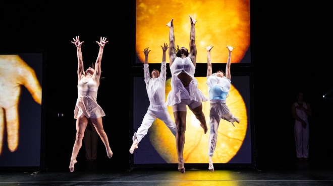 Dancers with their arms outstretched from "Still/JHere" by Bill T Jones Arnie Zane Company